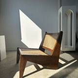 Reclined armchair in canned teak in natural wood