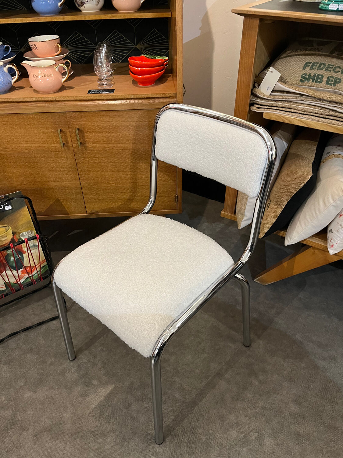 Pair of chrome chairs upholstered in boucle fabric.