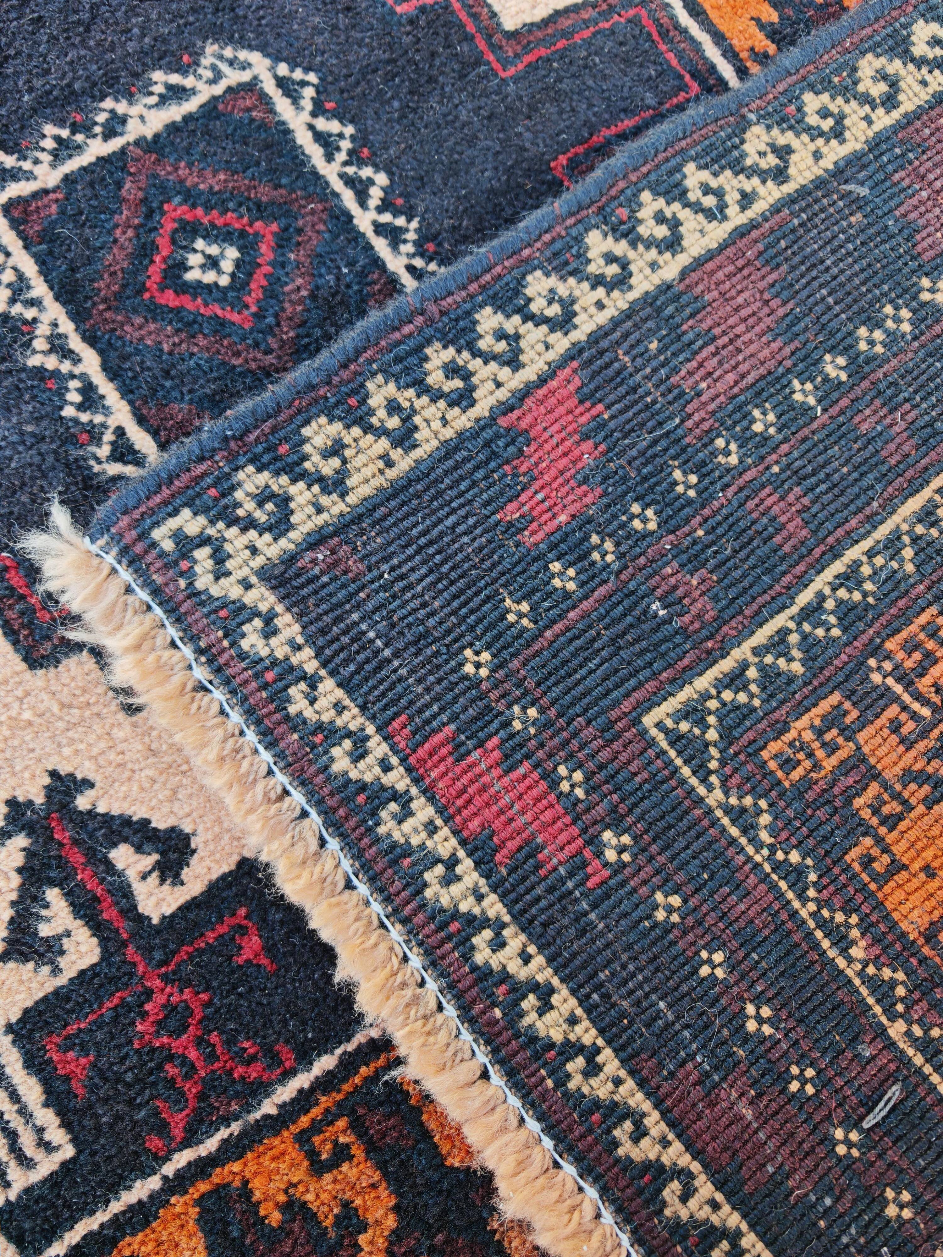 Vintage Persian Baluch rug, hand-knotted wool, 1970.
