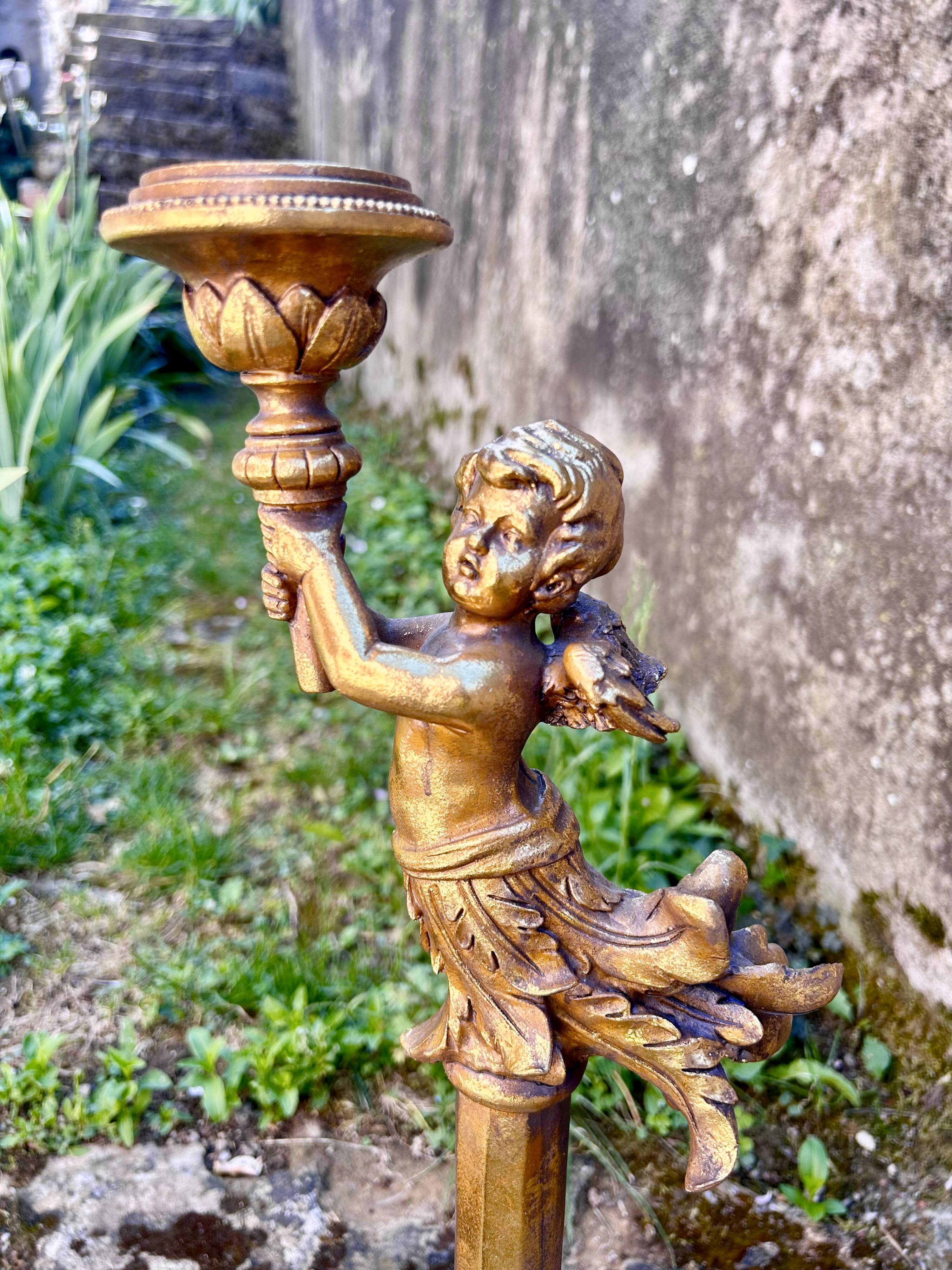 Pair of large candlesticks with cherubs
