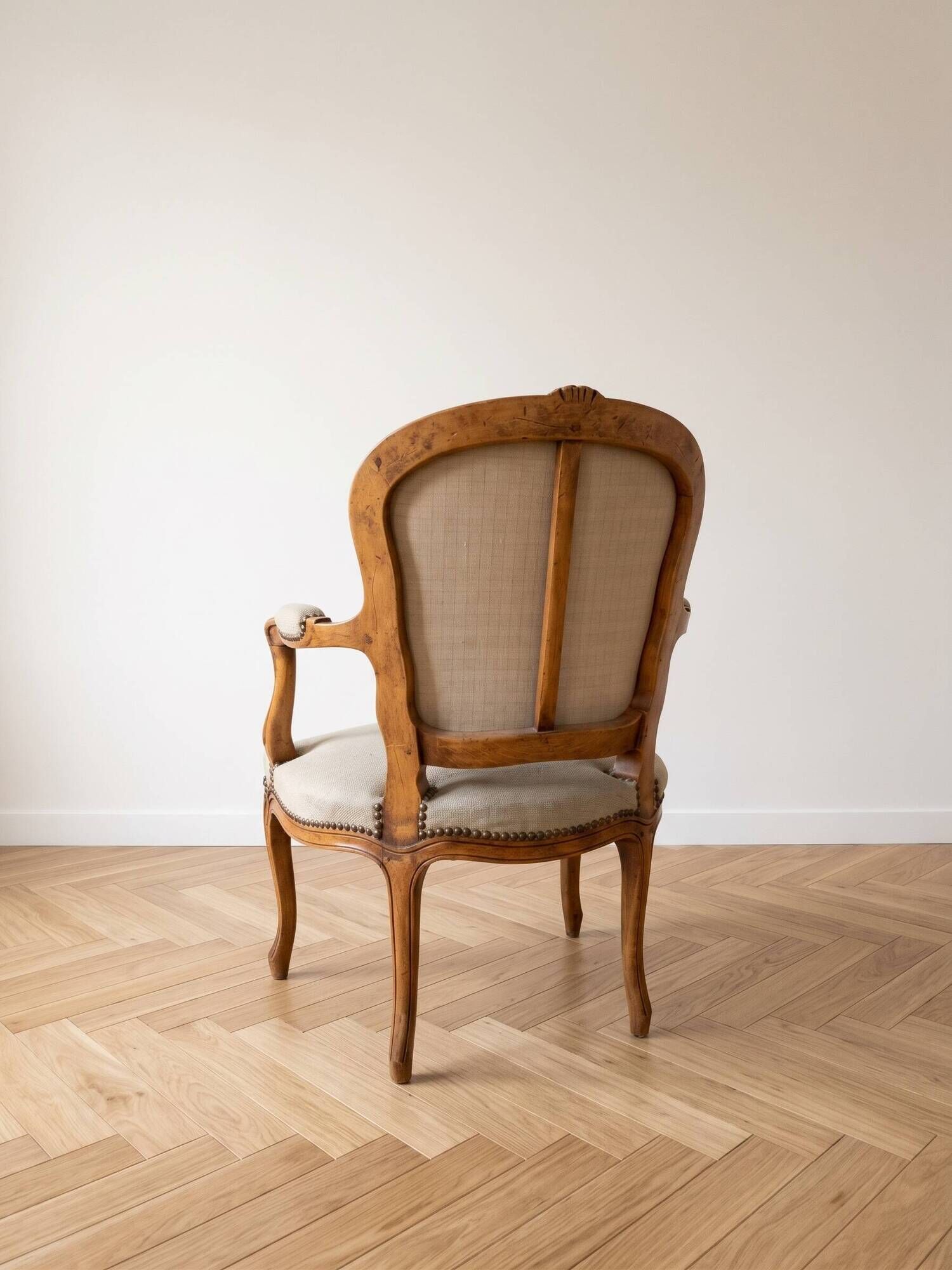 Pair of Louis XV/XVI armchairs in carved wood and floral fabric.