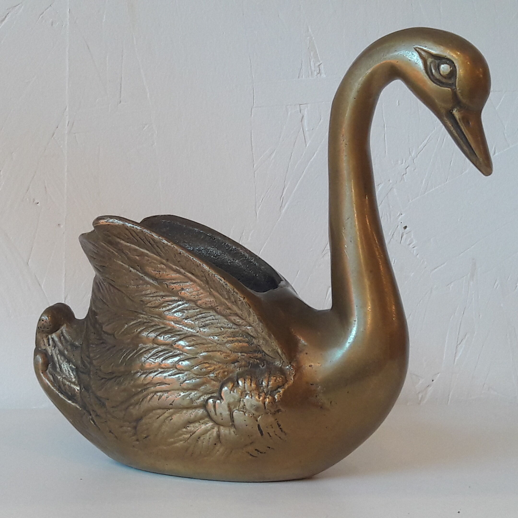 Empty brass swan pocket