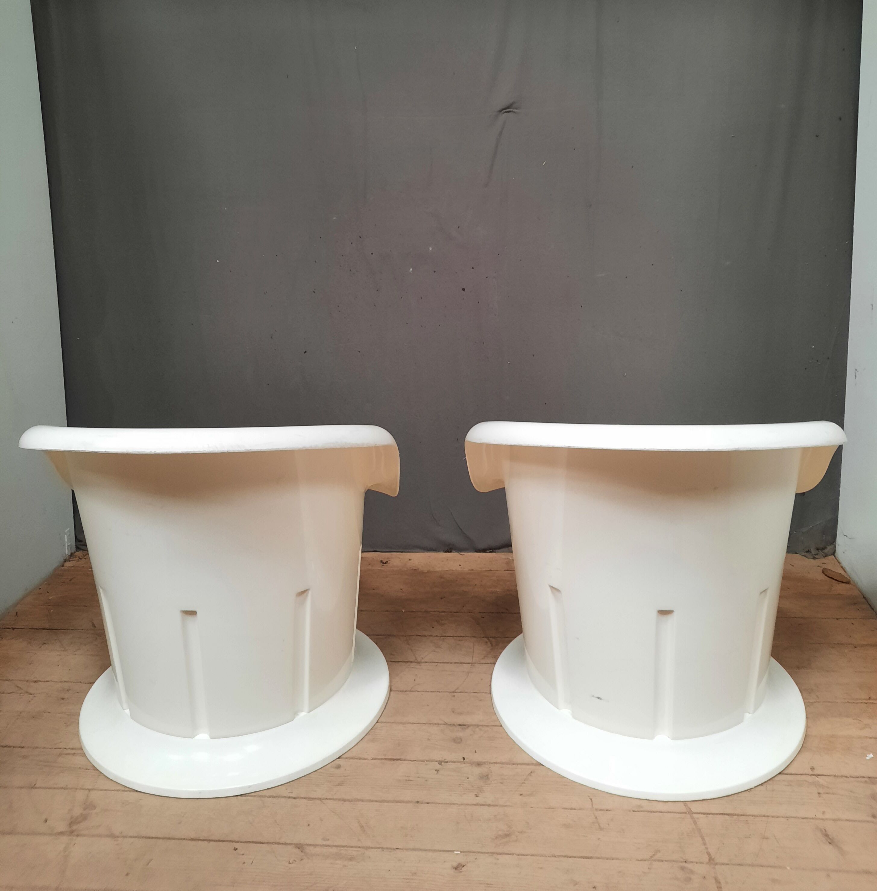 Pair of white plastic armchairs
