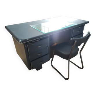 Old gray industrial desk and its retro chair