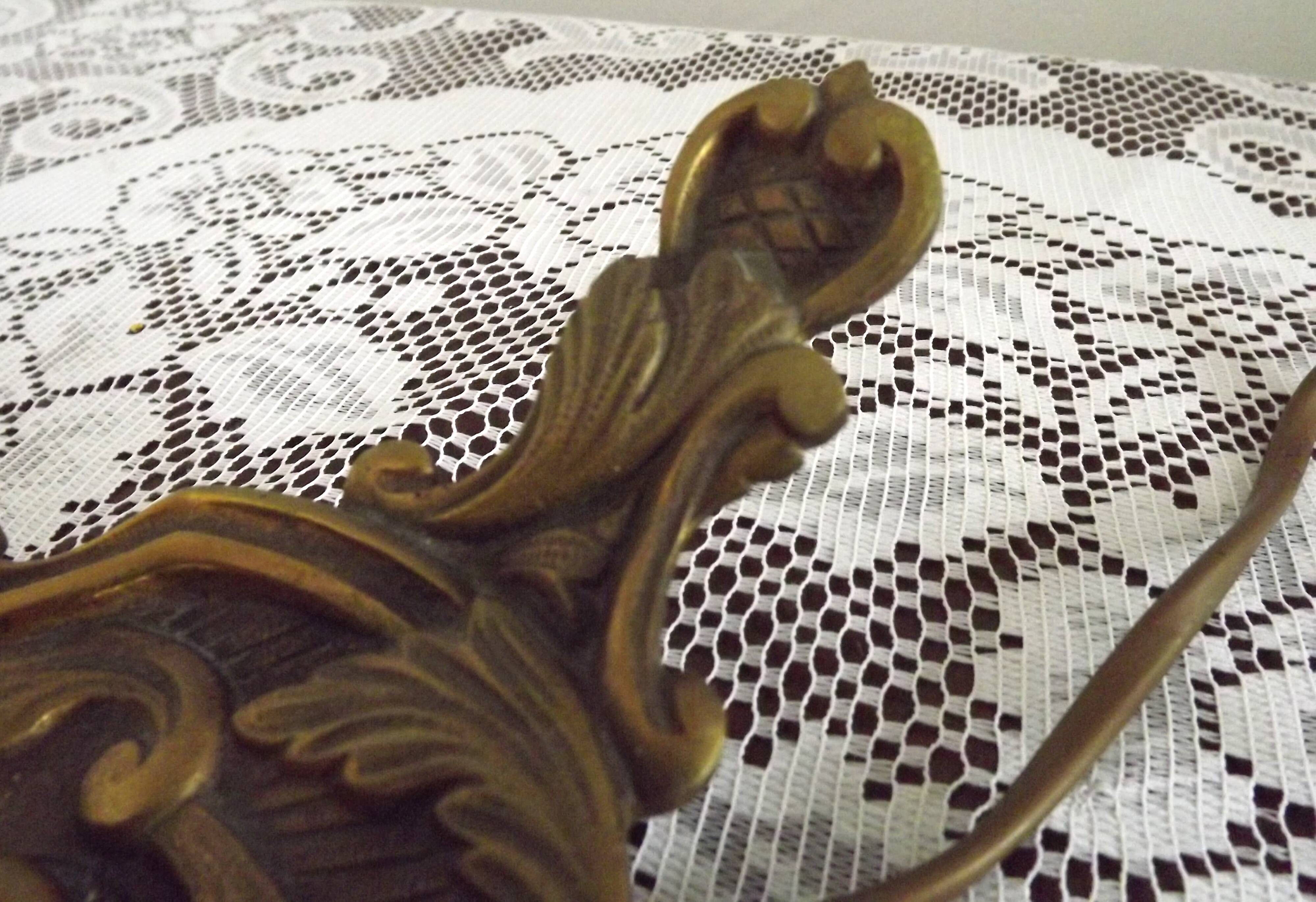 Vintage French bronze Wee Willie Winkie style lamp with red card shade.