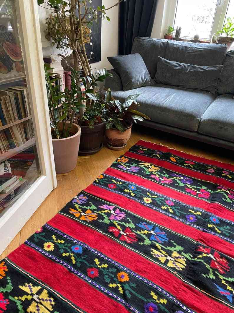 Romanian wool rug, red background with delicate colourful flowers