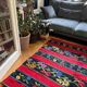 Romanian wool rug, red background with delicate colourful flowers