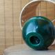 Lamp "ball" in green stained wood, raffia lampshade, 70s