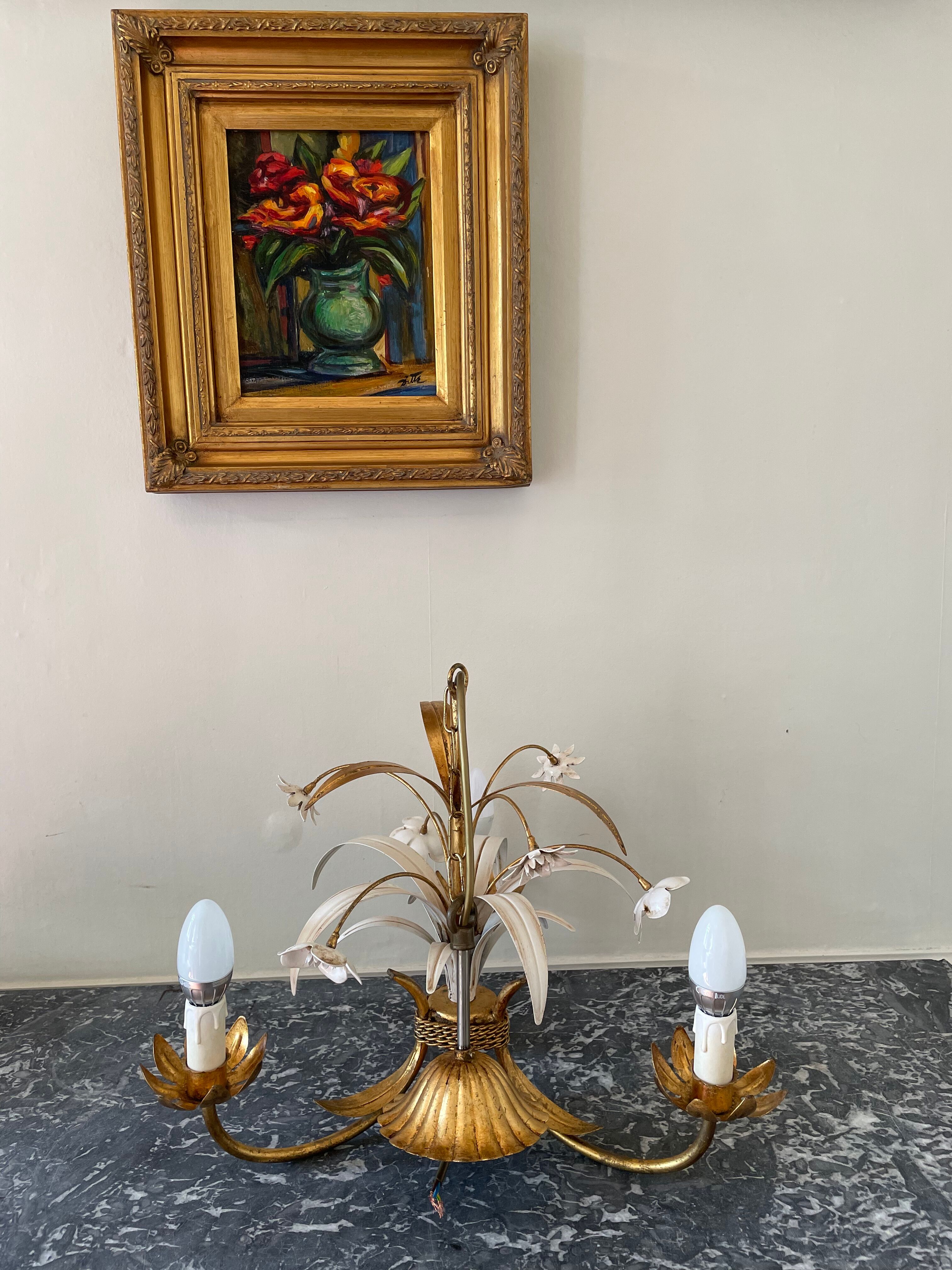 Golden metal chandelier decorated with flowers