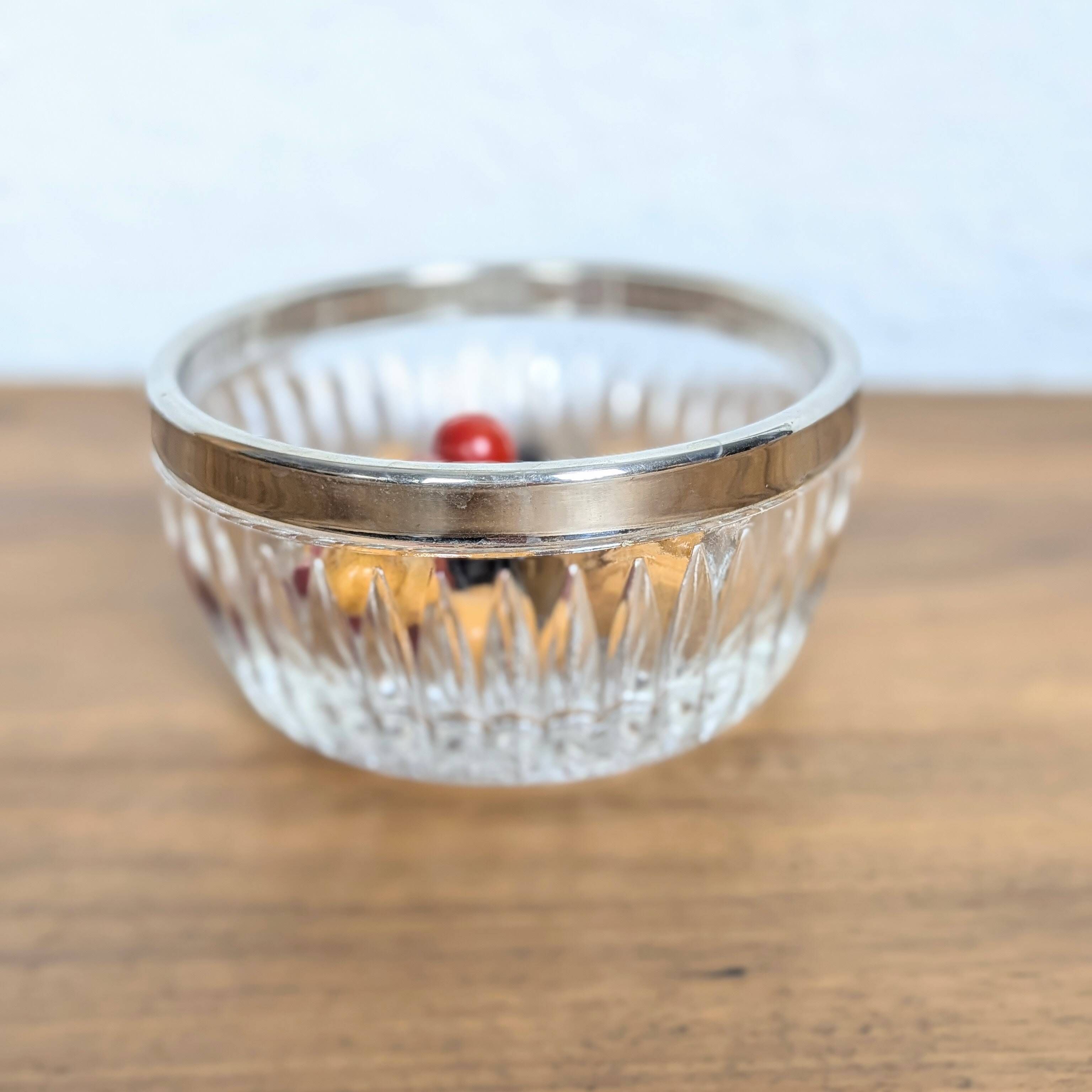 Cut glass bowl with silver-plated edge