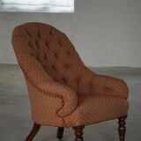 Victorian mahogany armchair, with wheels and coloured fabric, England, early 1900s.
