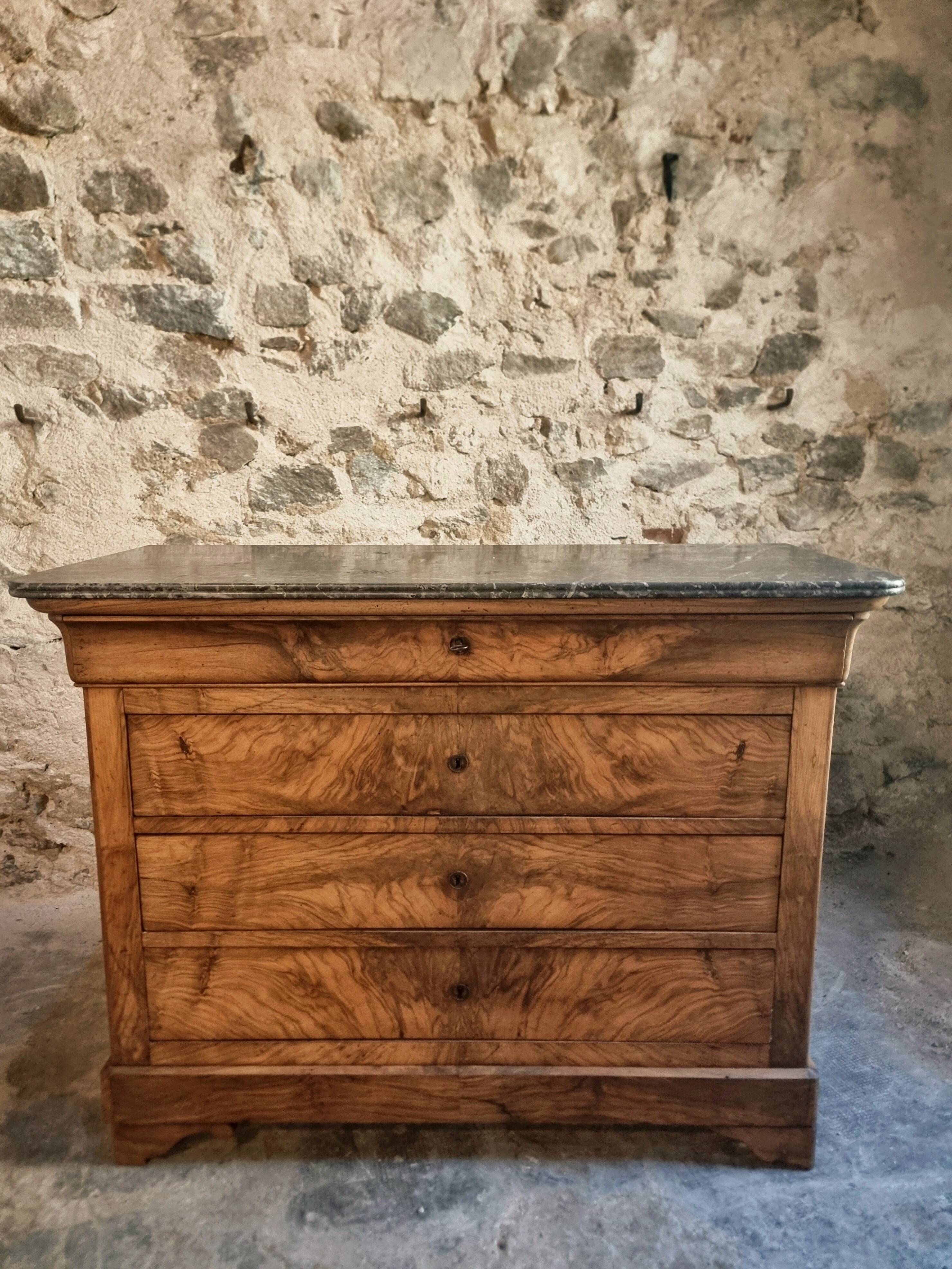 French antique walnut commode with a dark grey marble top, circa 1830–1860.