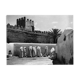 Women in white under the ramparts of Fez around 1930.