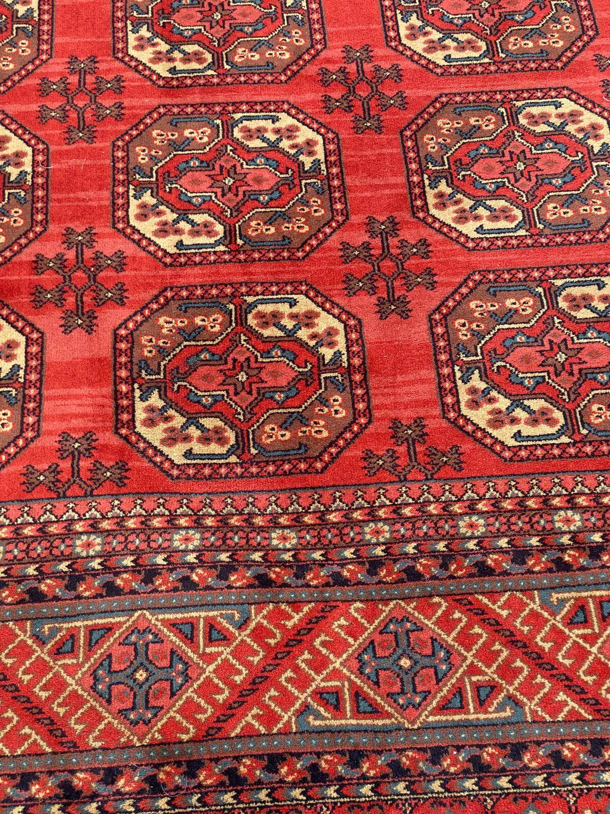 Tapis persan en laine rouge bordeaux Louis de Poortere 250x350cm