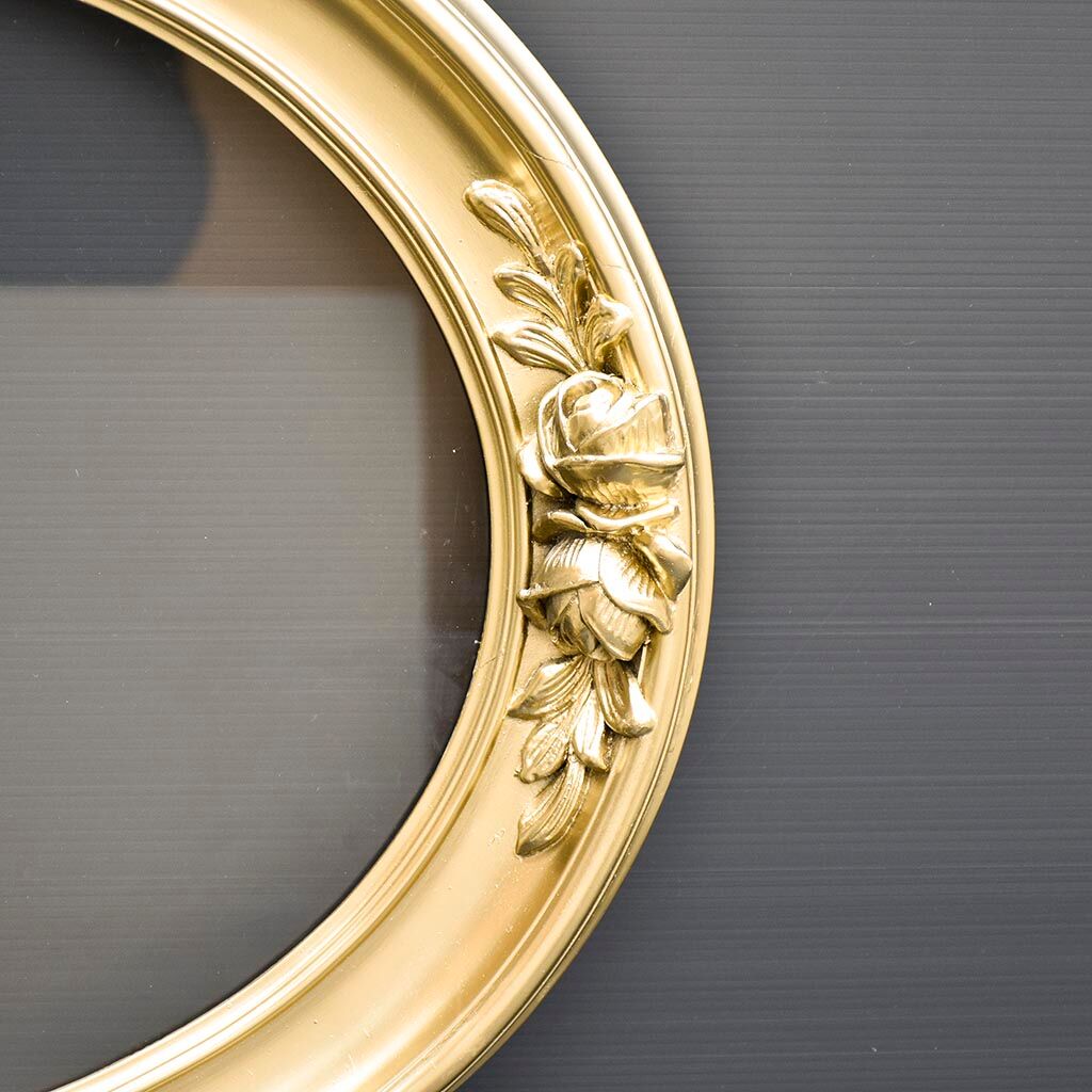Delightful empty old gilded oval frame with carved wood and stucco flowers 63 x 53