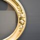 Delightful empty old gilded oval frame with carved wood and stucco flowers 63 x 53