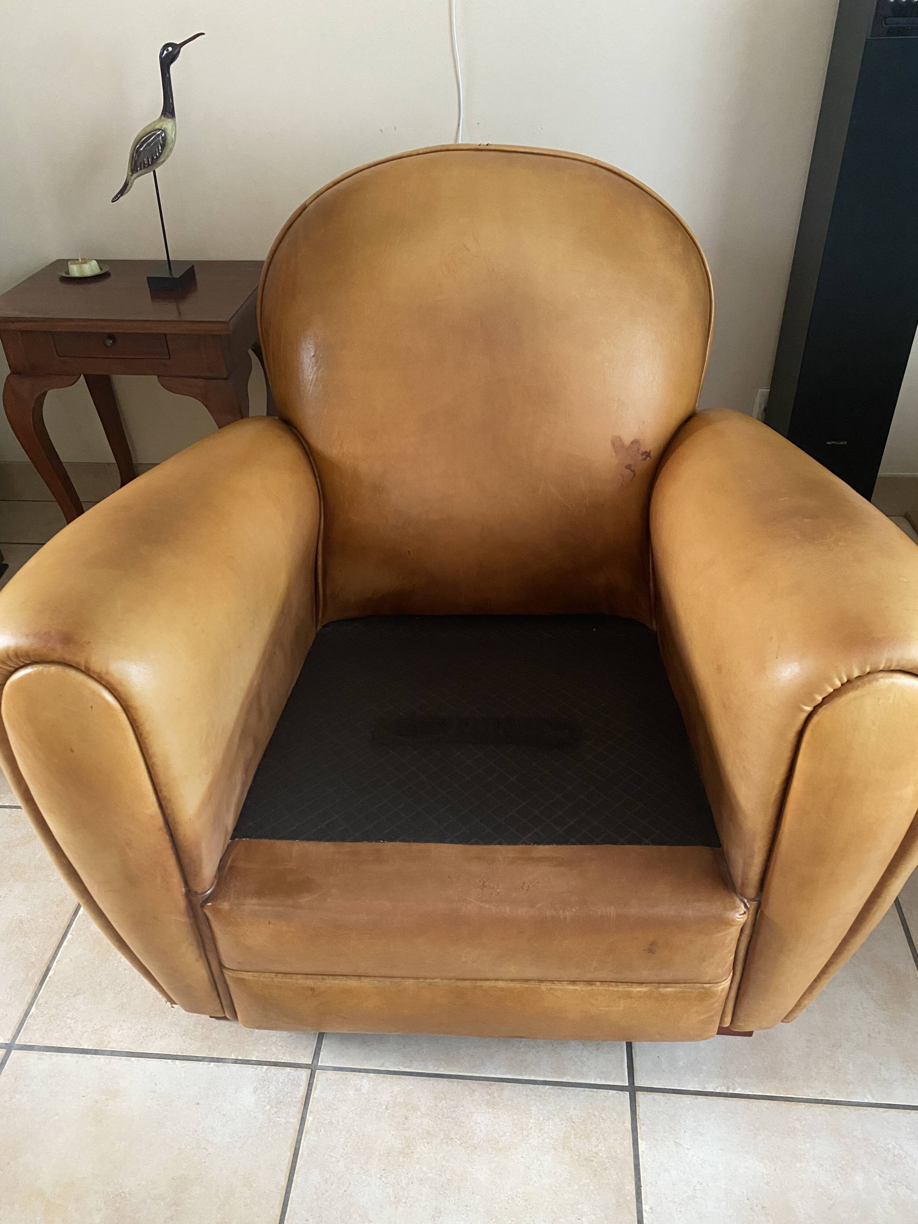 Brown leather club armchairs with an antique finish.