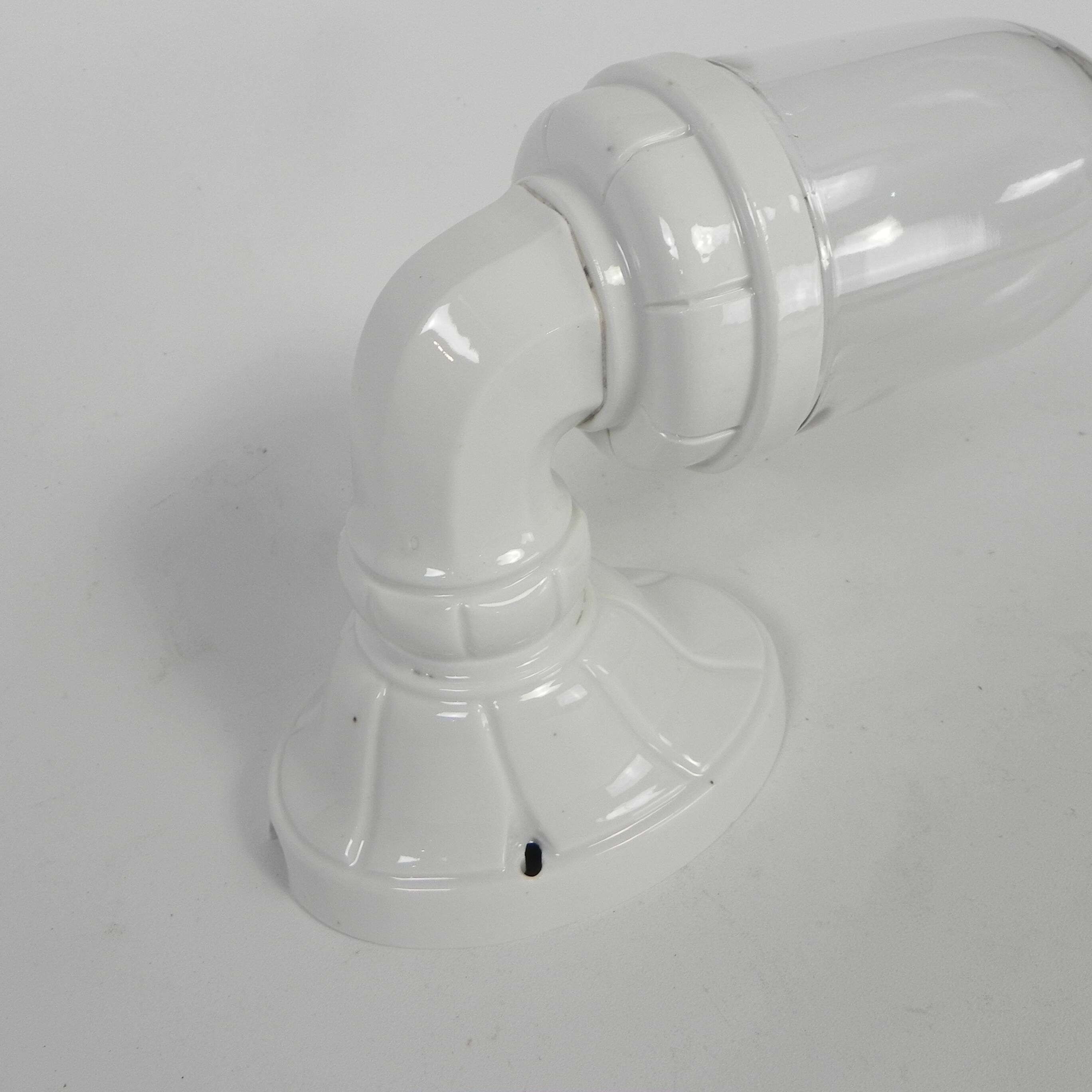 Wall lamp in porcelain with a transparent glass shade, 1930s.