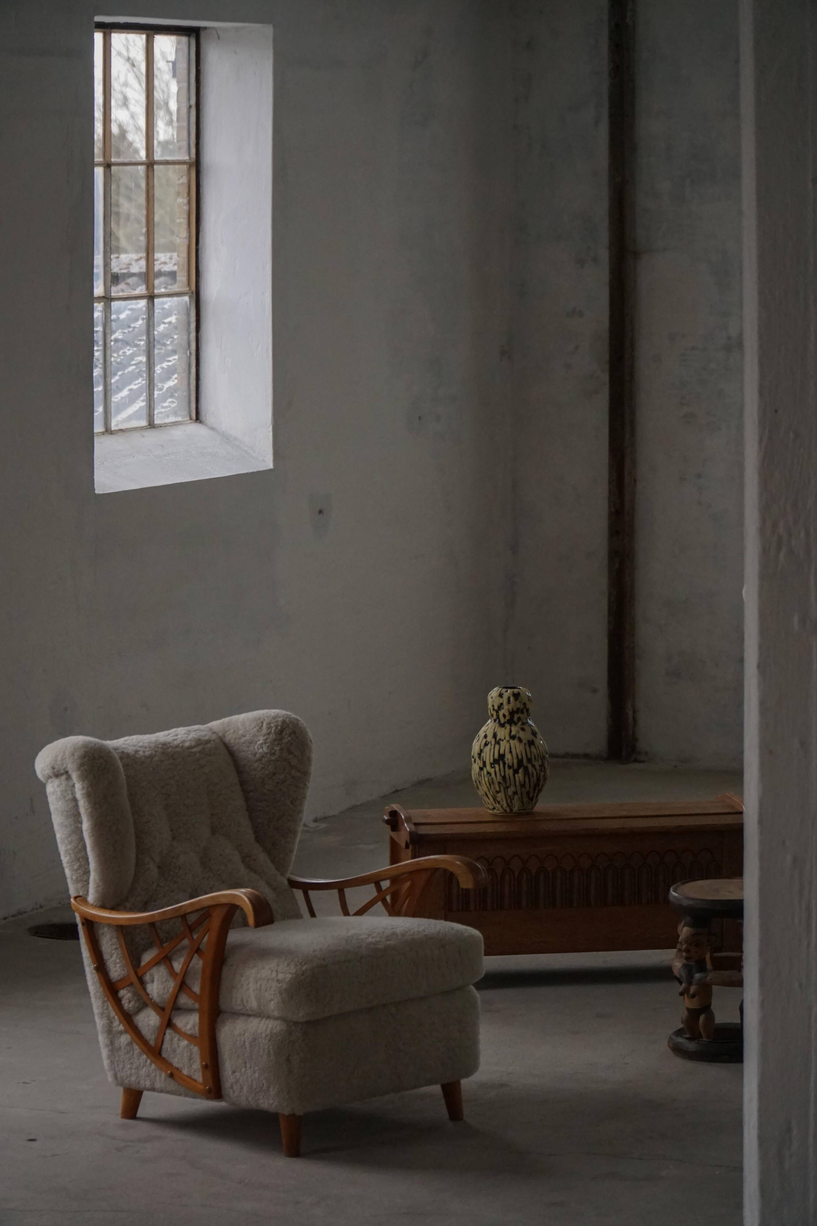 Pair of modern Swedish lounge chairs, shearling sheepskin and elm, 1940s.