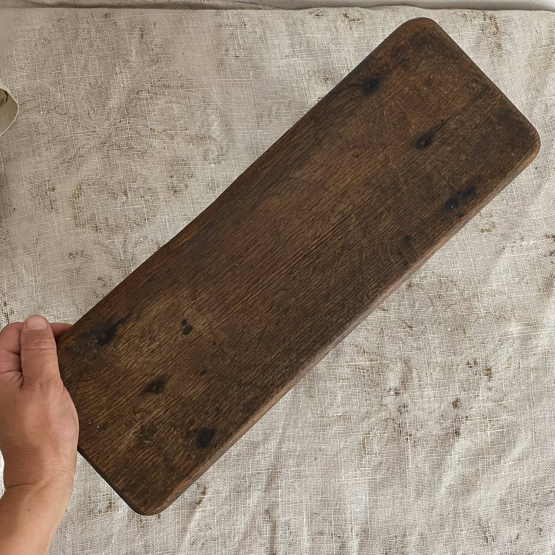 Old low stool made of solid wood