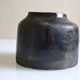 Ceramic vase with a signature fish to identify.