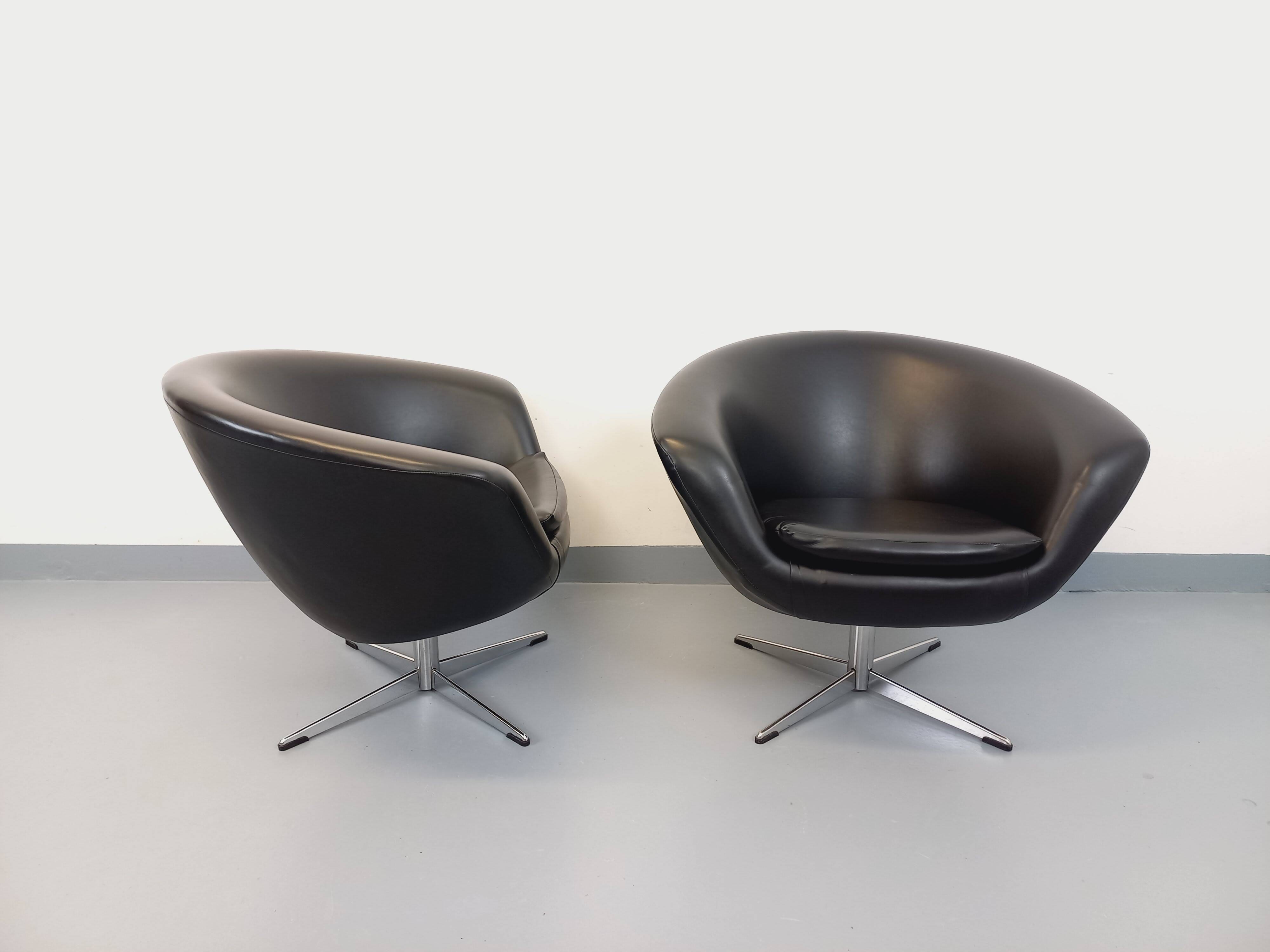Pair of vintage Scandinavian swivel armchairs in faux leather and chrome.