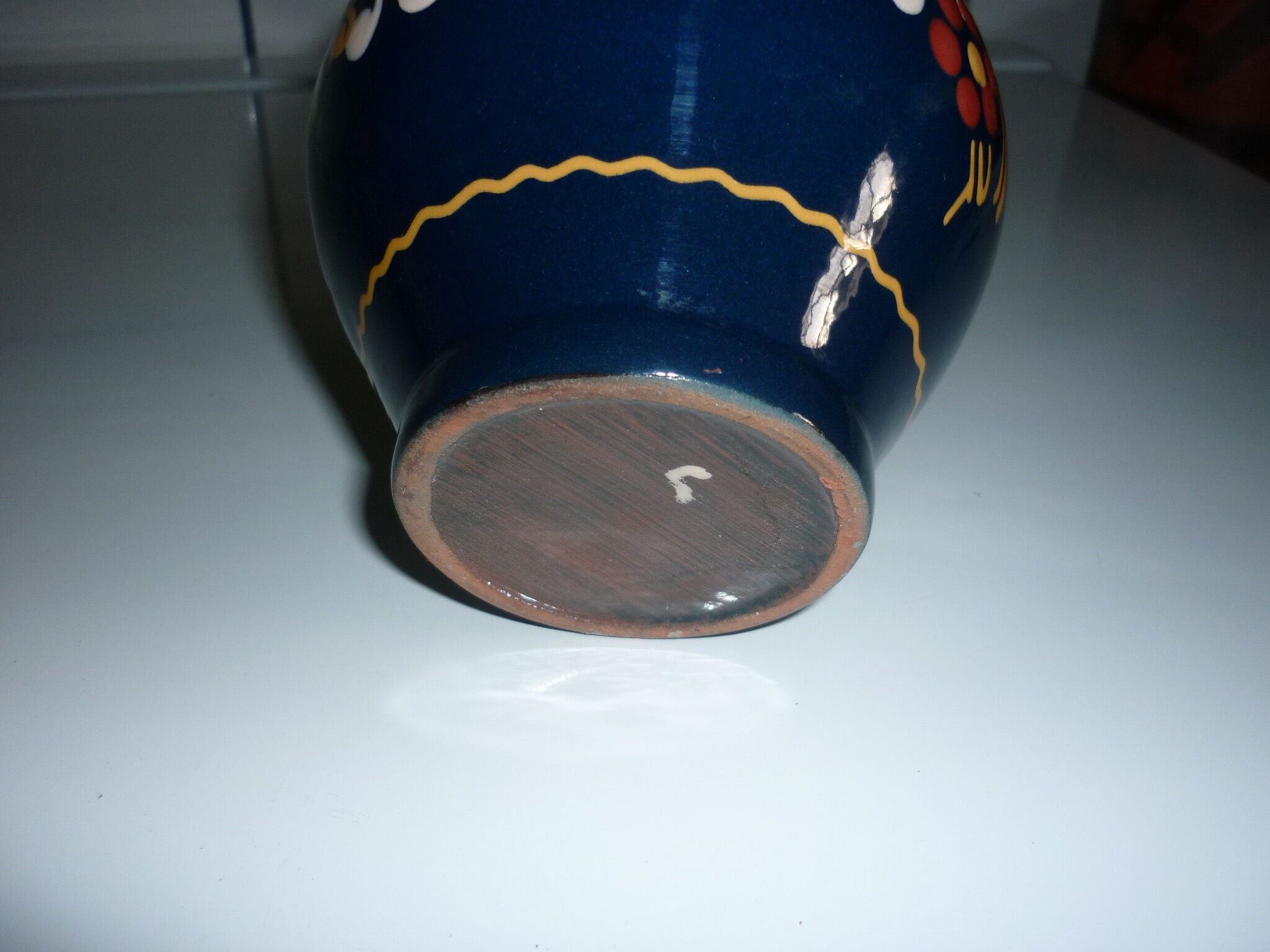 Blue glazed earth pitcher and flowers