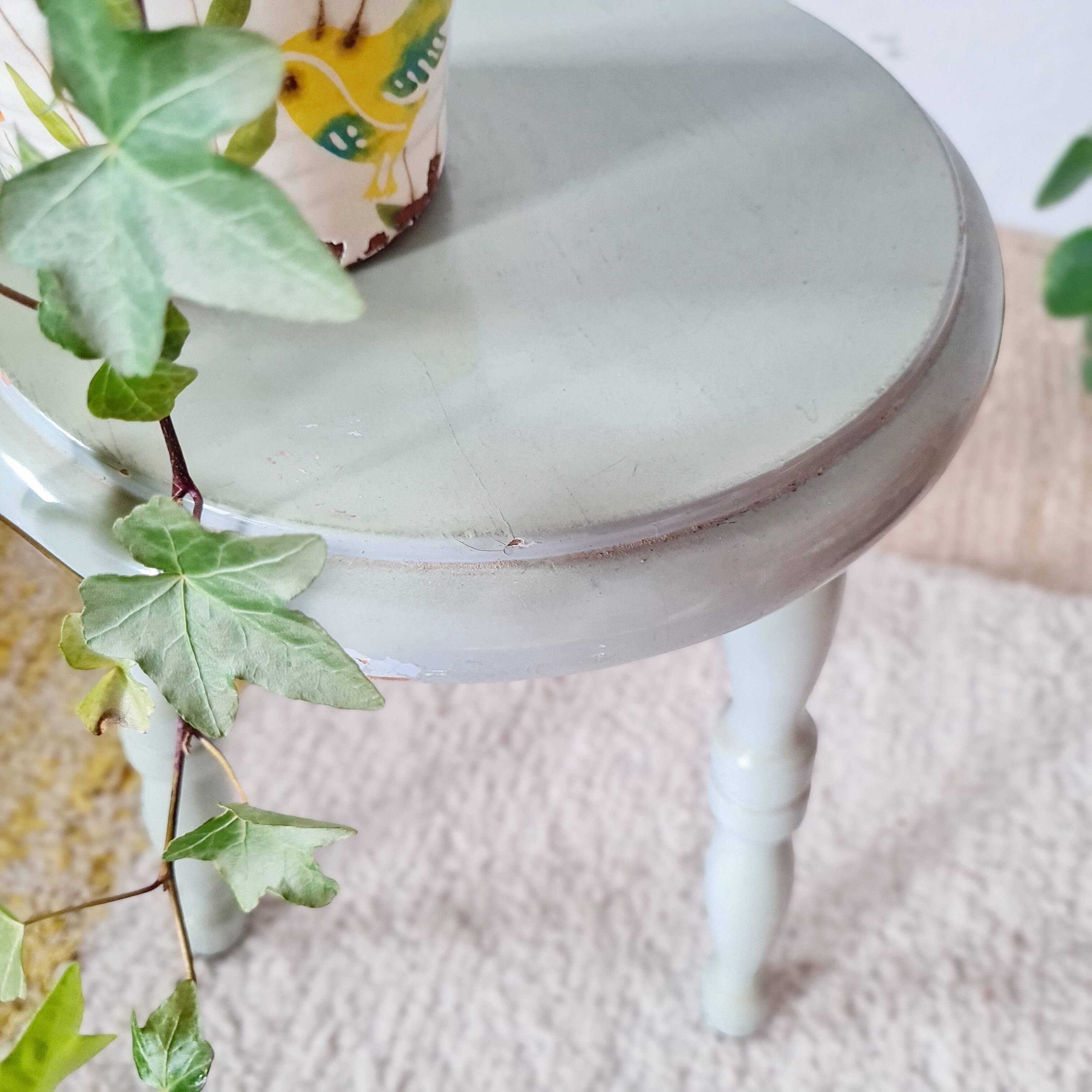 Antique tripod stool made of solid wood in blue.