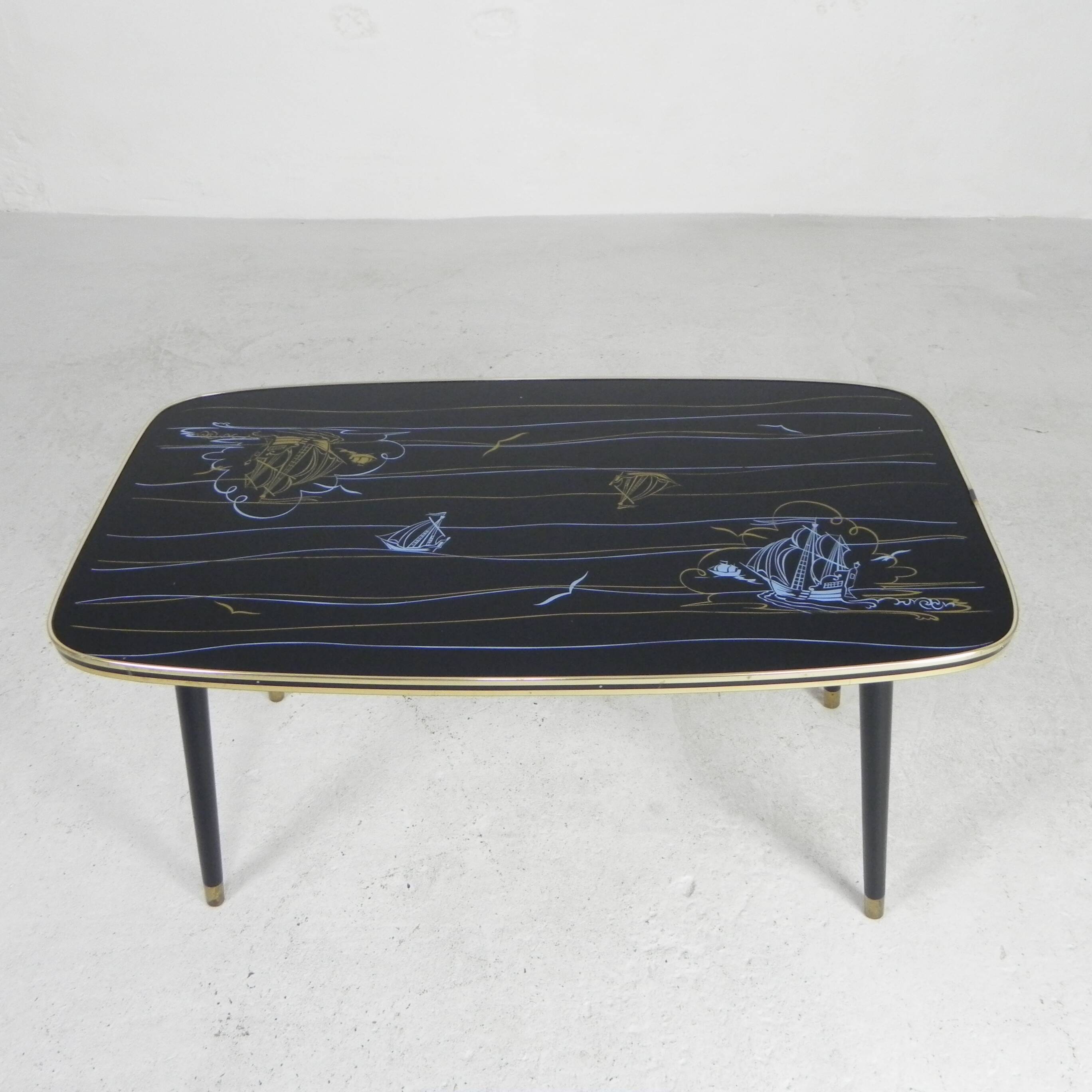 Vintage coffee table with glass top and angled legs