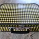 Antique suitcase in vintage yellow and black cardboard