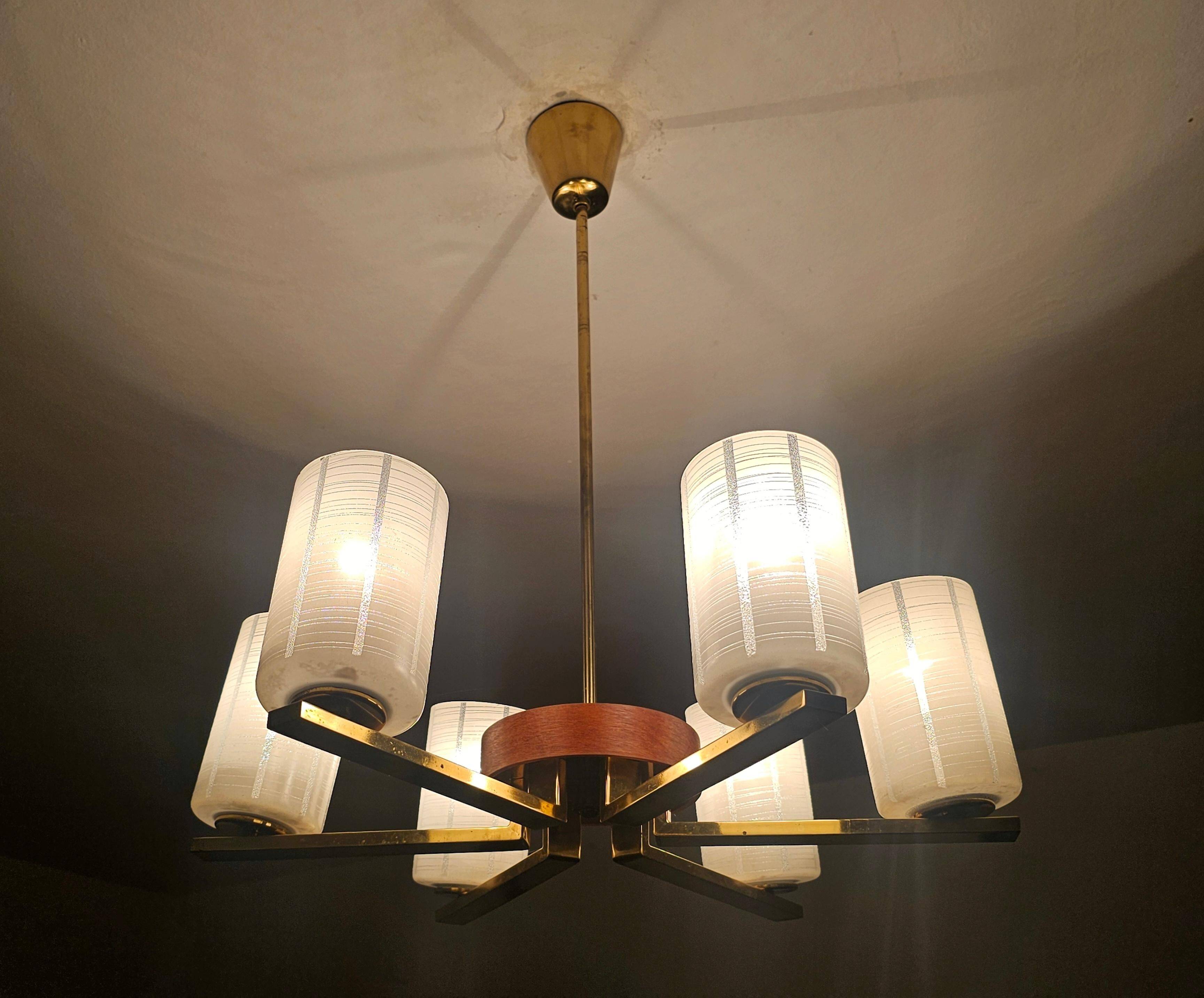 Lustre Mid Century Modern with 6 brass arms, teak, and frosted glass.