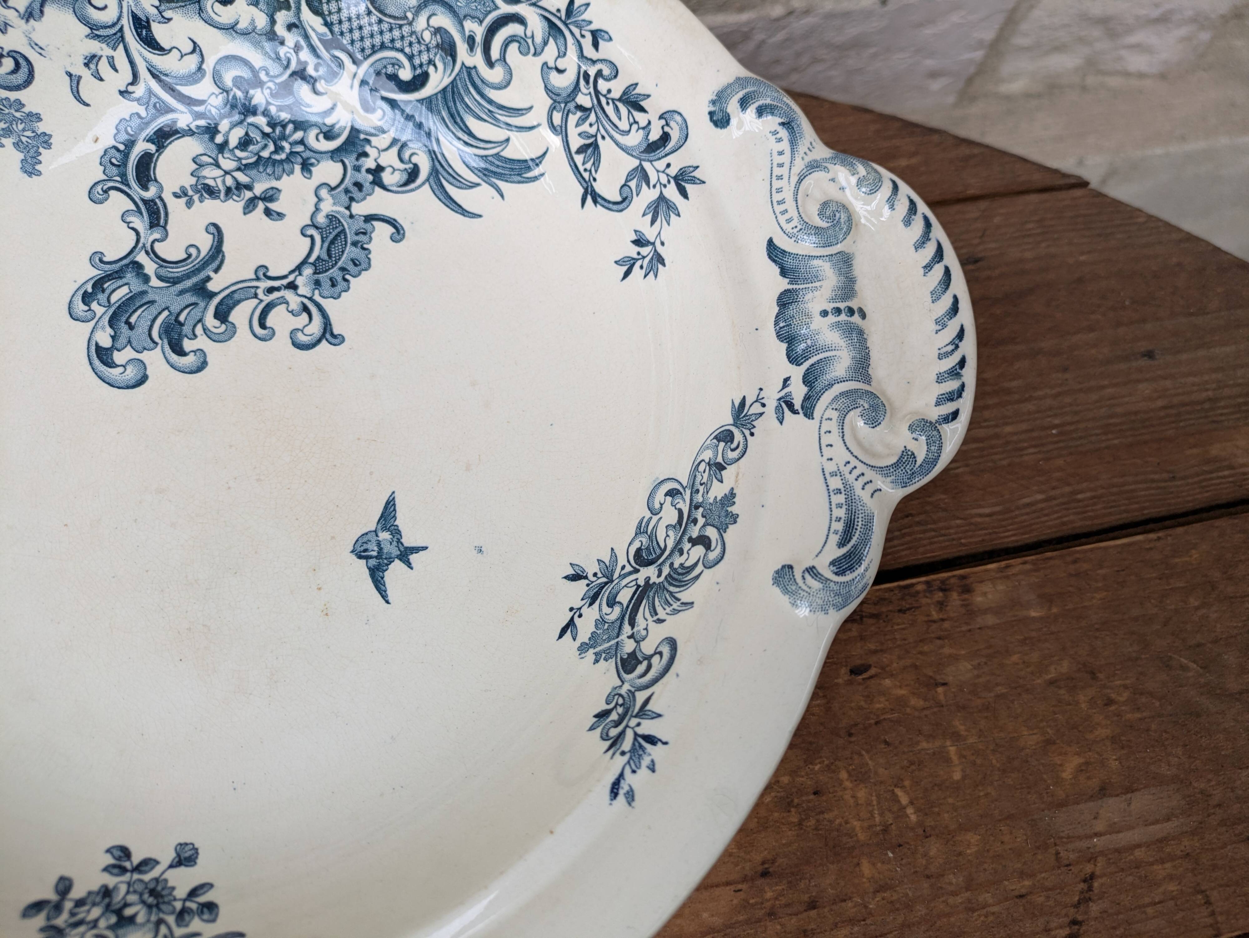 Shallow round plate Boch Frères model Regent with arabesque and foliage decoration.