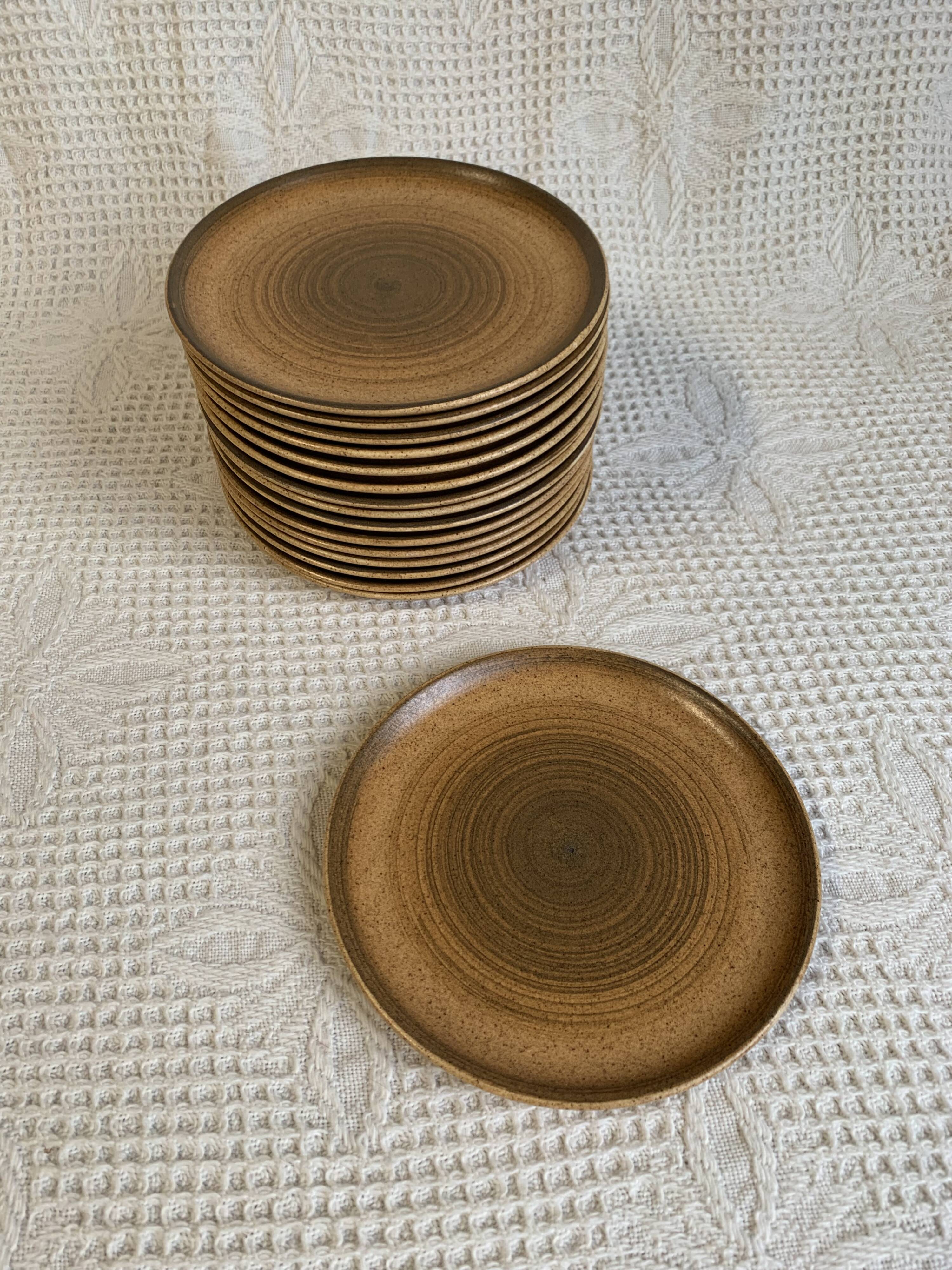 8 Longchamp enamelled stoneware plates, 1970