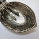 silver metal nutcracker in the shape of vintage walnuts