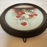 Oval painting of a bouquet of flowers, oil on panel.