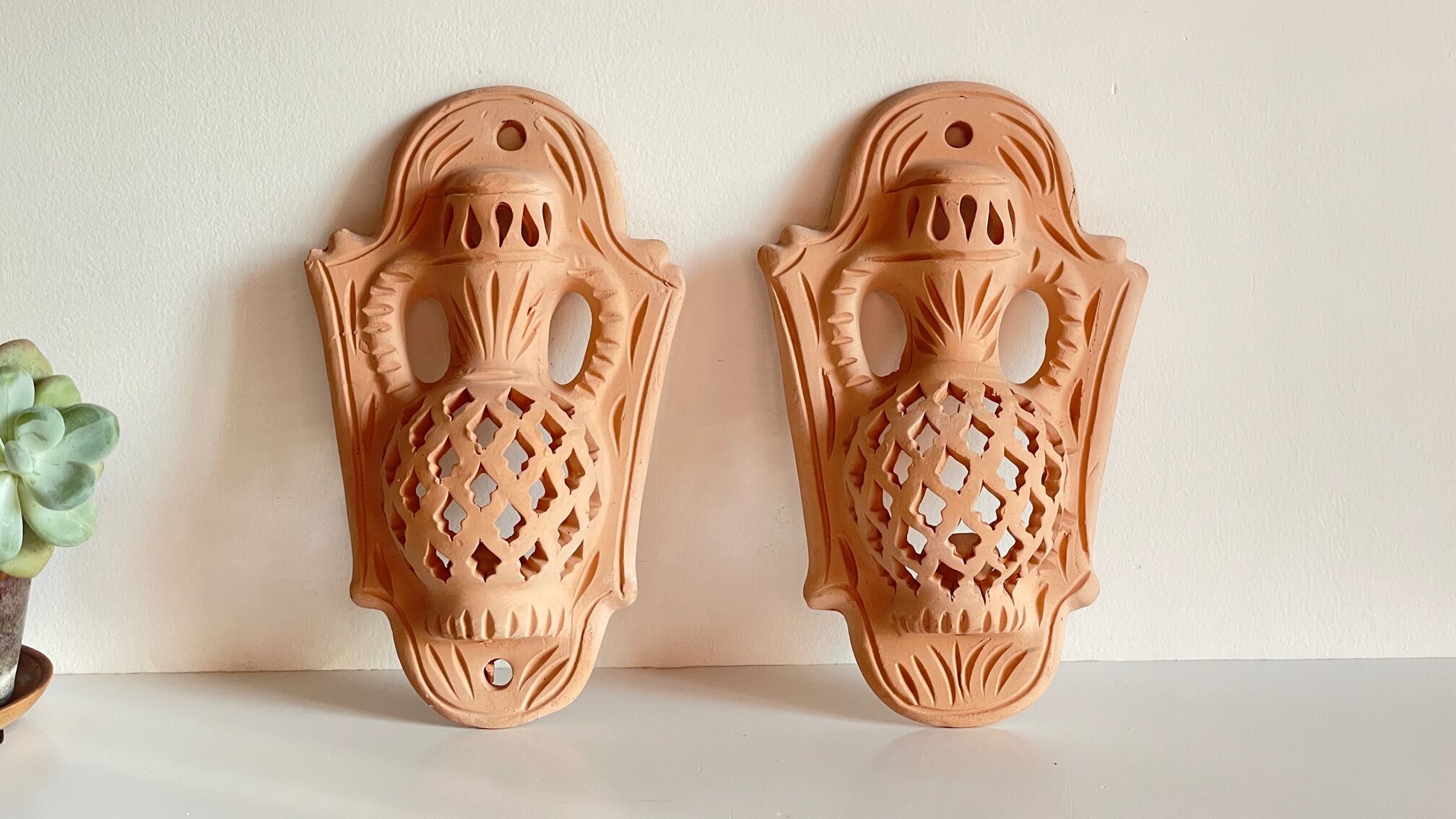 Pair of terracotta wall candle holders