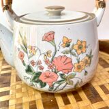 Vintage teapot in stoneware handle in rattan