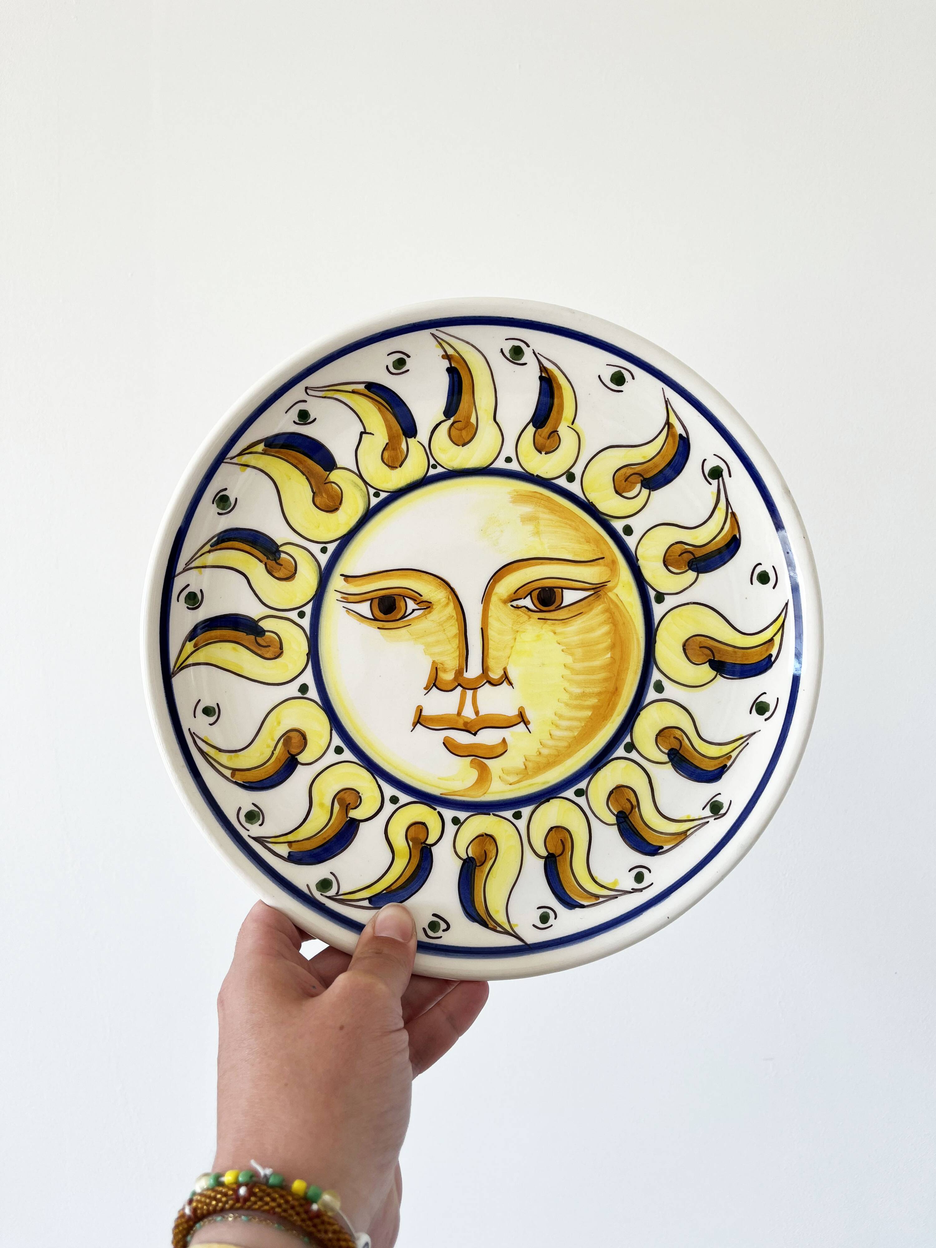 Decorative ceramic plate with sun face