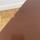 Brown coffee table with tapered legs.