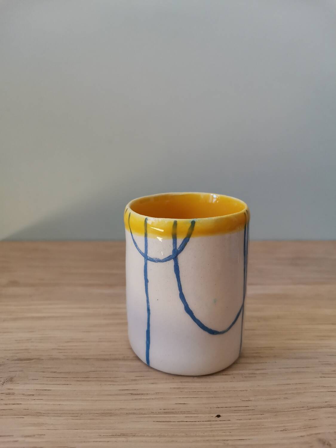 Handmade ceramic coffee cup blue yellow line