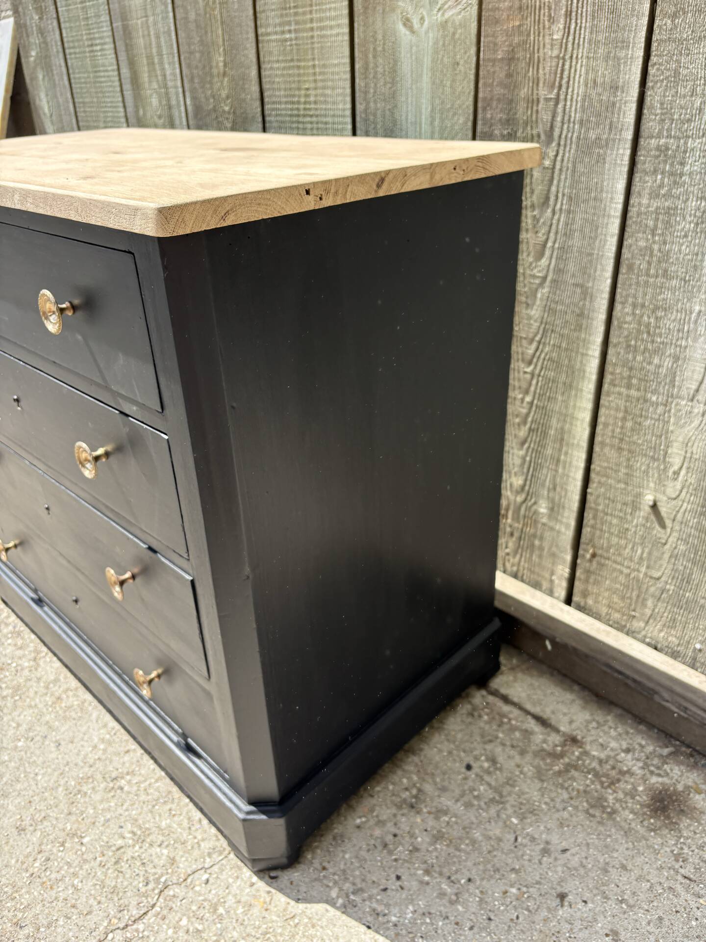 Antique commode with a matte black finish.