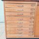 Workshop furniture with drawers and curtain in beech and walnut.