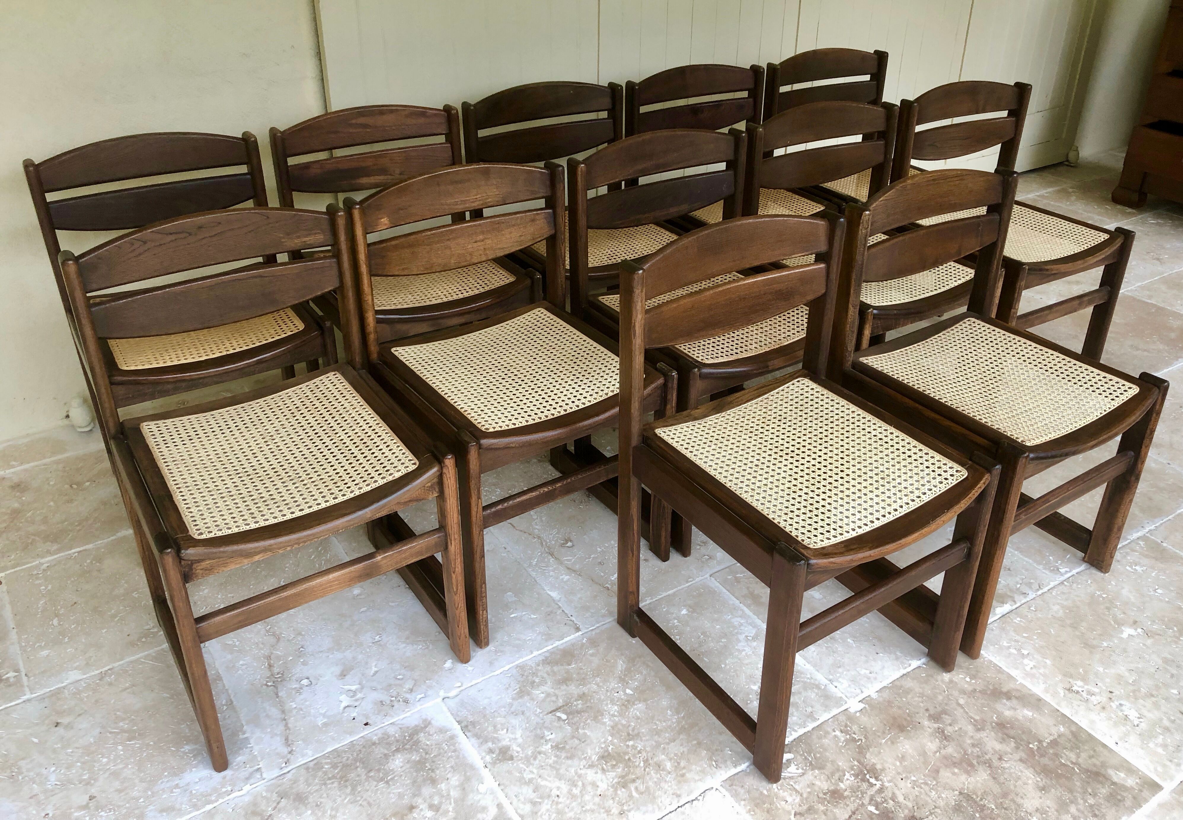 Set of 12 "sledge" dining chairs in walnut and cane.