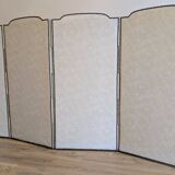 Vintage white faux leather screen with four studded panels, elegant decor.