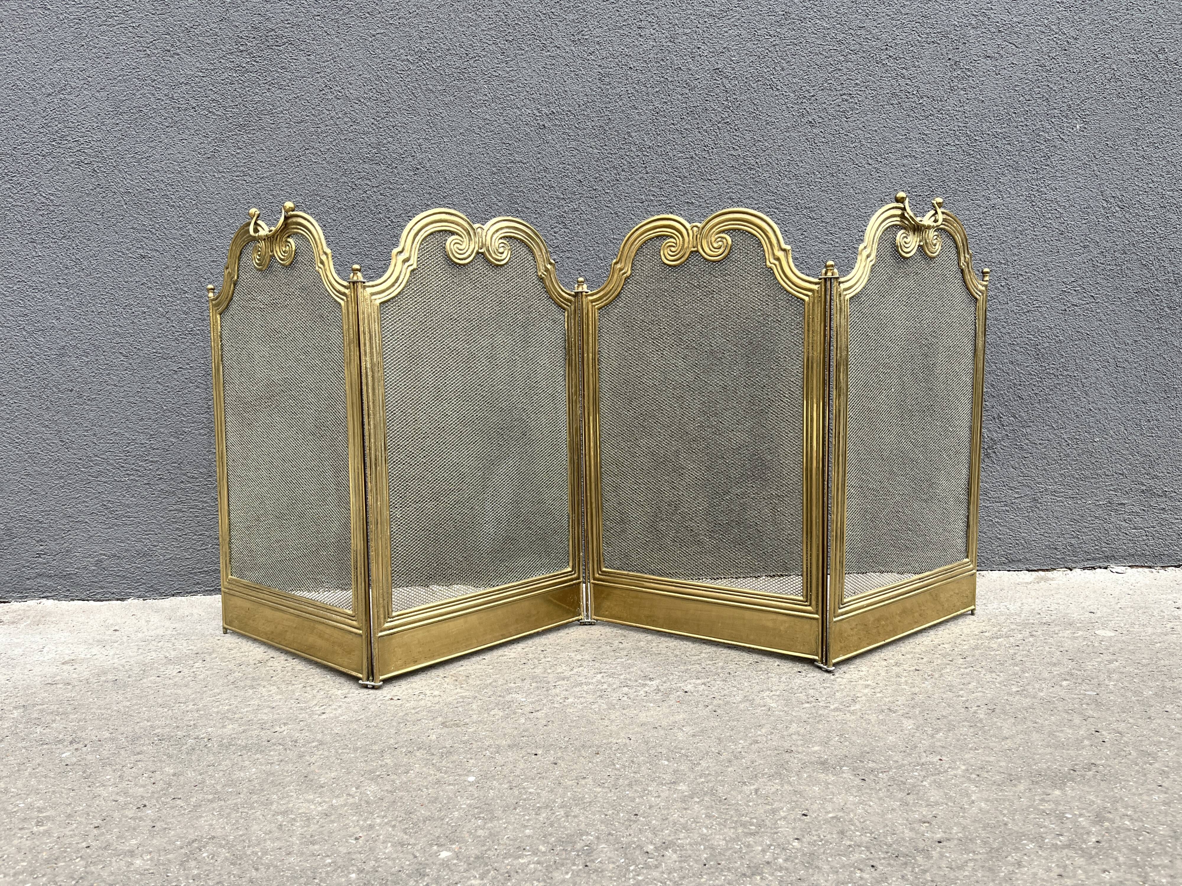 Antique brass fireplace screen from 1920, vintage spark guard.