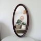 Oval antique mirror in solid wood from the 1960s.