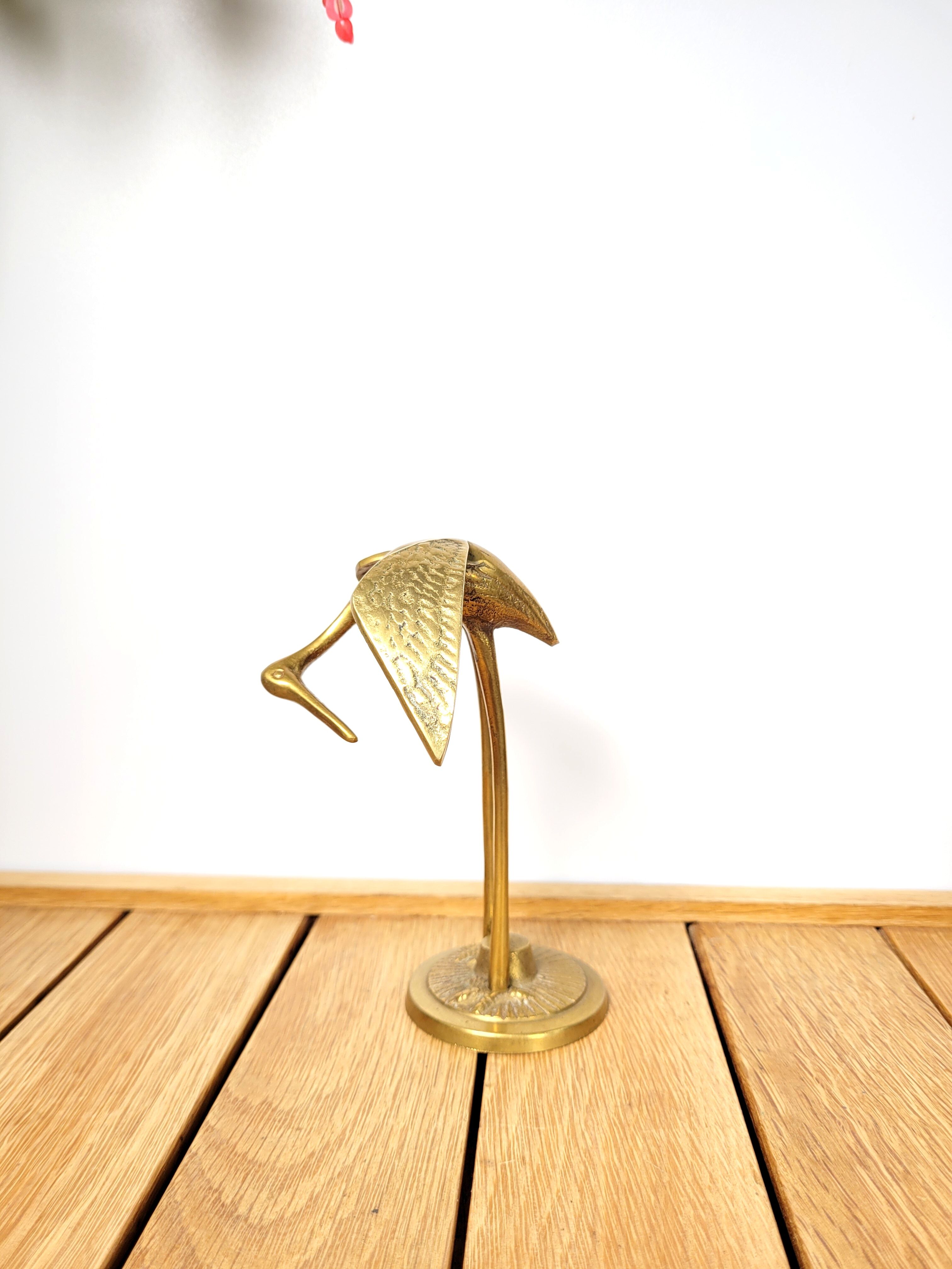 Brass heron head down