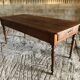Antique Louis Philippe style farm table in solid cherry wood with turned base.