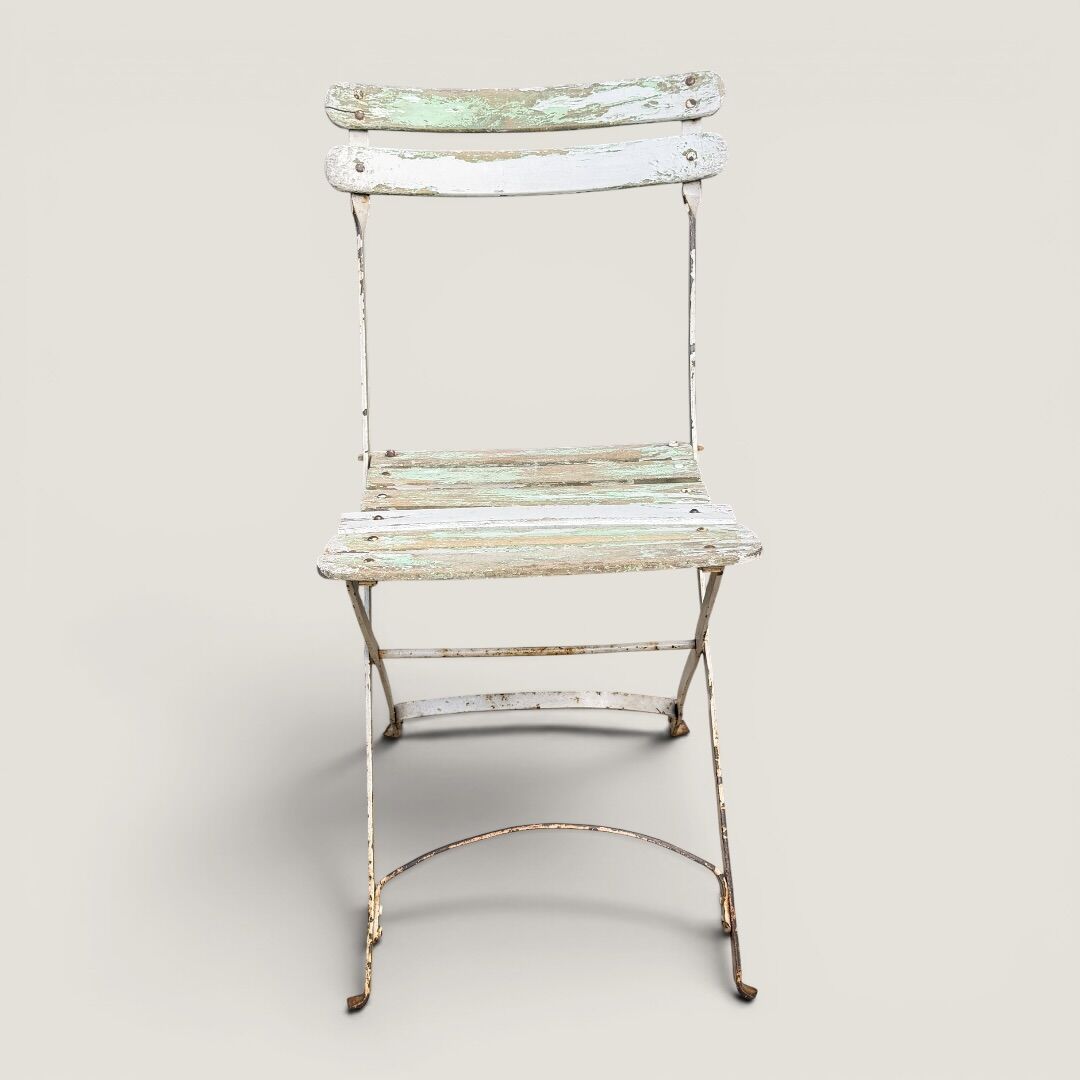 Bistro tables and folding chairs with a patina from the original 1930s.