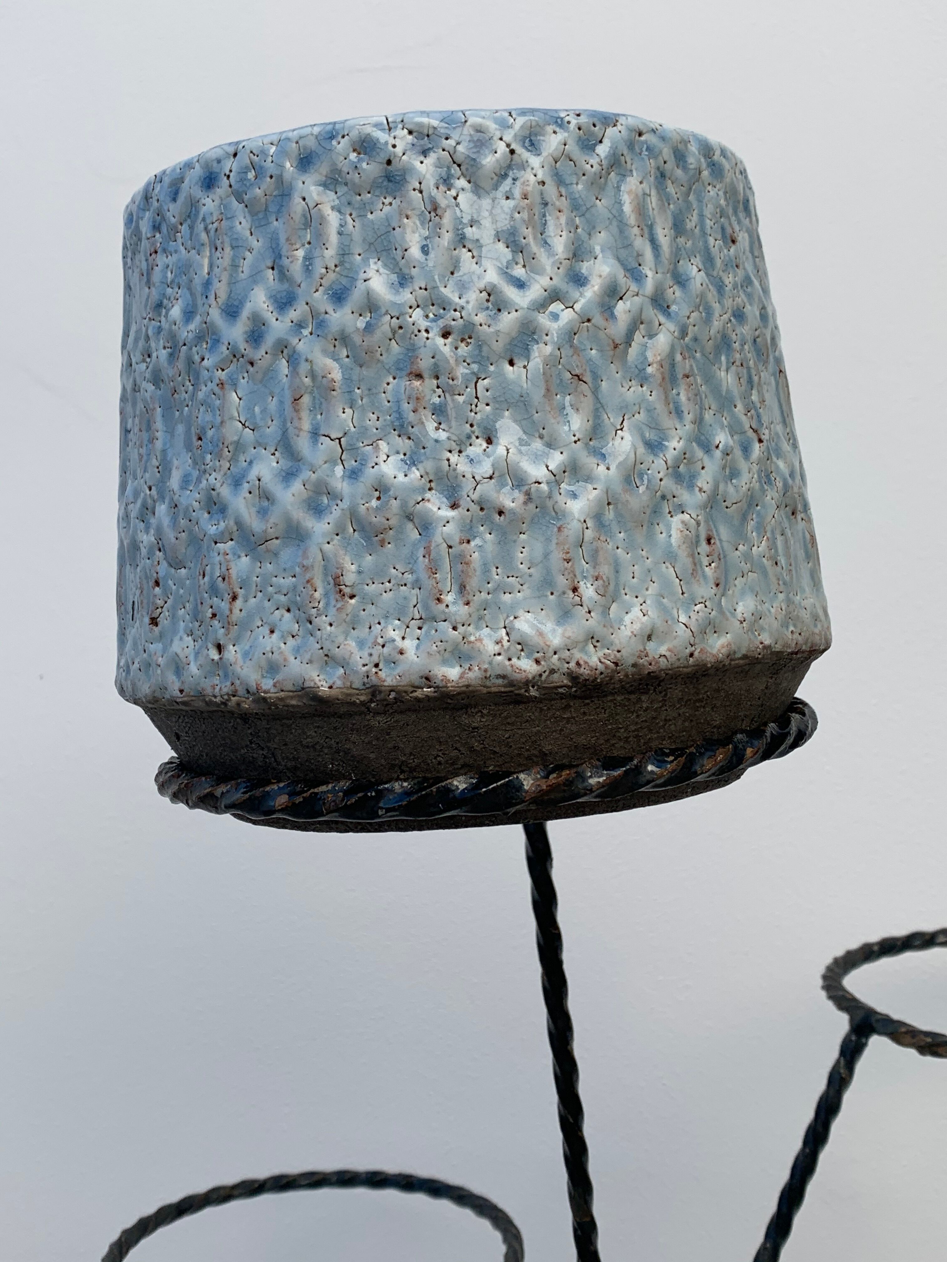 Black metal tripod plant holder